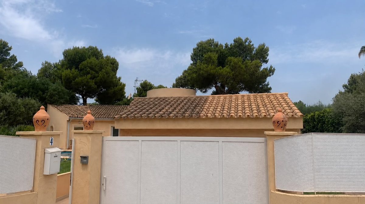 Mallorca villa with terracotta roof behind its gate